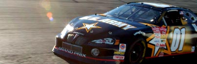 Photo of The Army NASCAR vehicle on the race track.