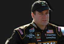 Photo of NASCAR Driver, Jerry Nadeau standing in front of The Army Racecar.
