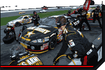 Photo of the U.S. Army NASCAR Team Pitcrew in action during a race.
