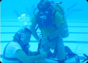 Many hours are logged underwater when training to become an Army diver. Here a student learns how to "ditch and don" his SCUBA gear in case of emergency.