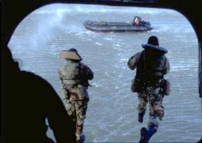Army Divers jump from a CH-47 Chinook helicopter into a river. Divers practice these "helocasts" at different speeds and heights as part of the demanding training they go through.