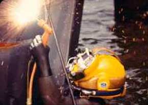 An Army Diver uses an ultrathermic cutting torch to repair an Army amphibious transport. With this equipment, the diver can cut through virtually any material, since the rod burns at approximately 10,000 degrees.