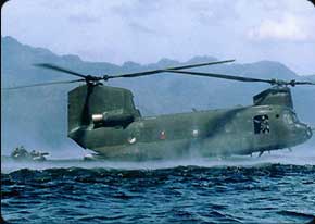 The CH-17 prepares to pick up a Zodiac loaded with Army divers. The 15U Crew Chief helps guide the pilot with radio feedback from the side window.