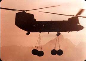 A Chinook transports four 500-gallon fuel tanks. The Chinook is the "Workhorse of the Army," carrying everything from personnel to vehicles to supplies wherever they are needed.